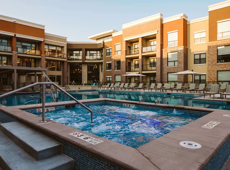 outdoor hot tub surrounded by apartment homes